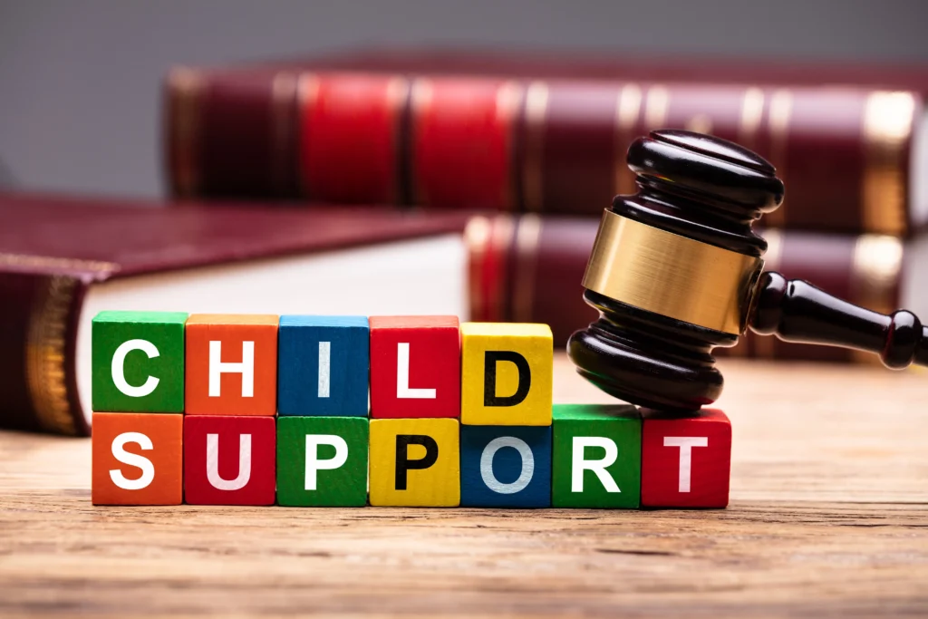 Colorful blocks spelling child support with gavel on top, symbolizing legal action in Houston.