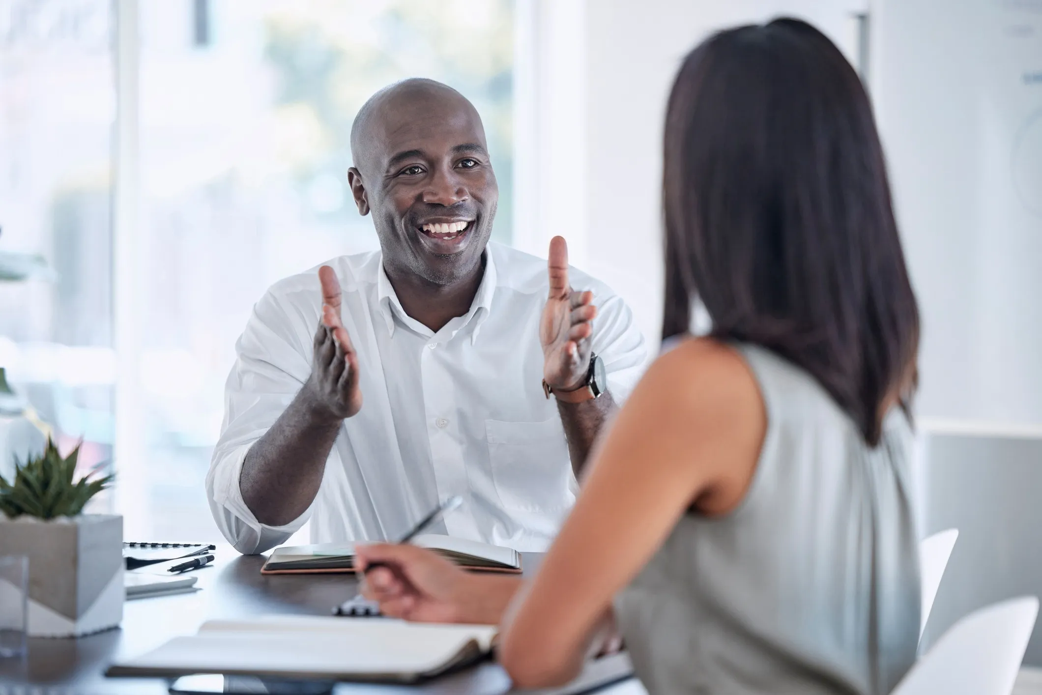 Collaborative divorce attorney in Houston explaining legal process to client taking notes.
