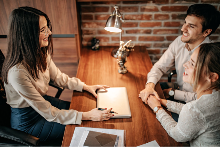 couple holding hands meeting with a family law attorney