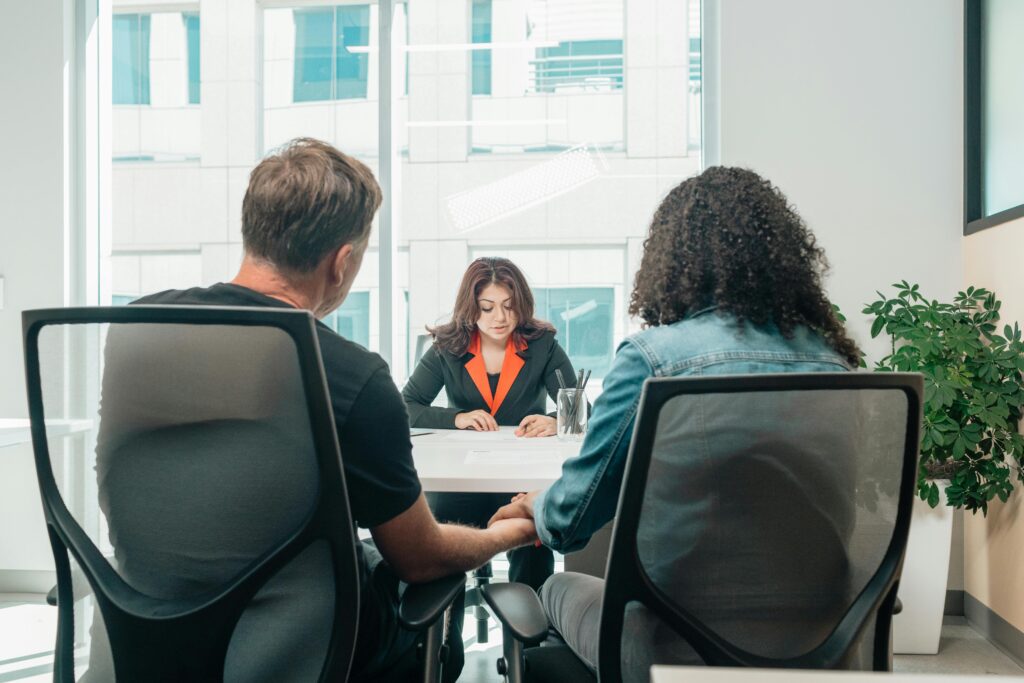 couple meeting with woman adoption lawyer