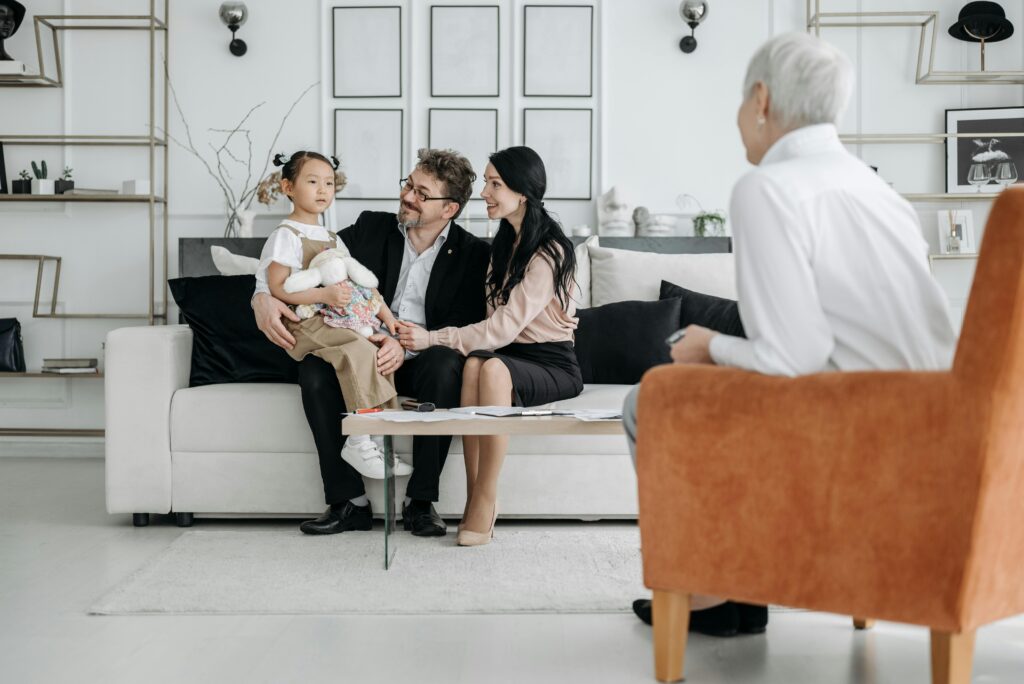 couple on couch with adopted child and adoption lawyer